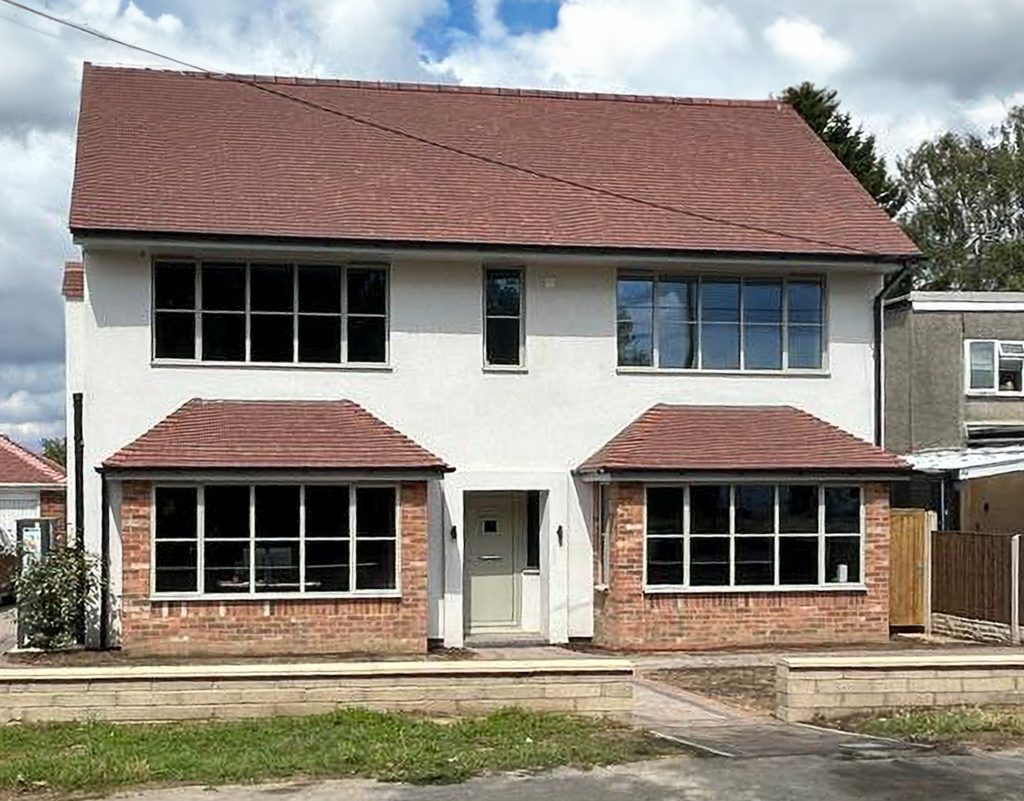 steel look windows in white at the front of a detached house