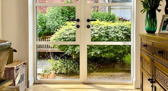 inside view of white heritage door in a dining room setting with wood floor