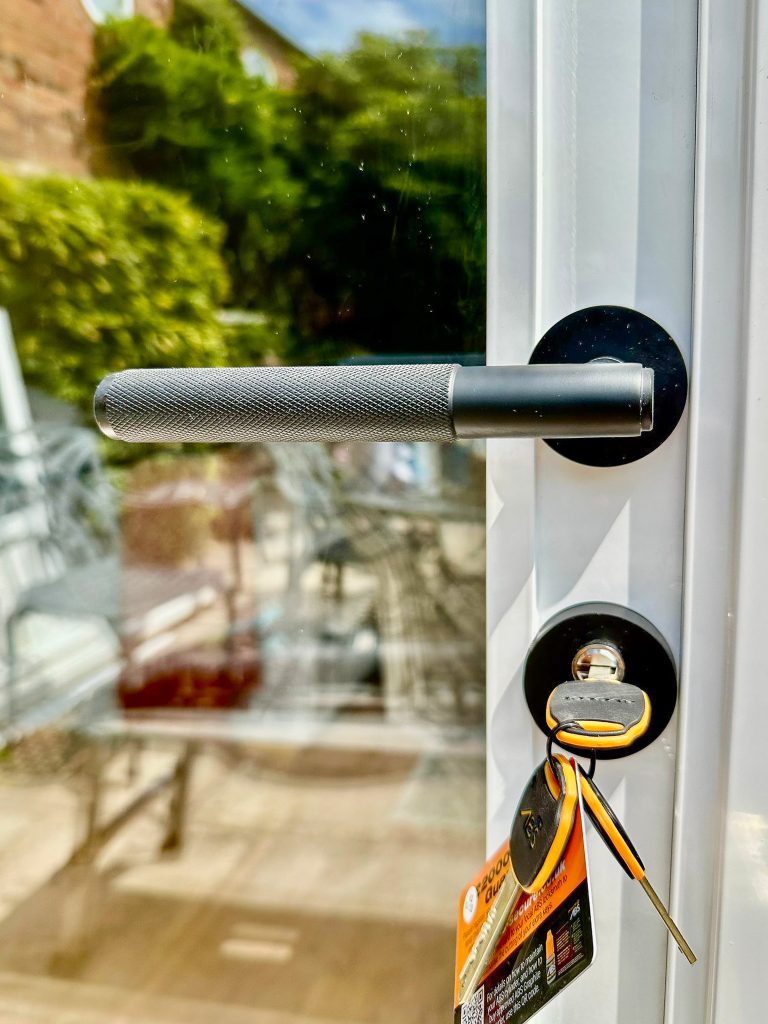 close up of black heritage handle against a white door