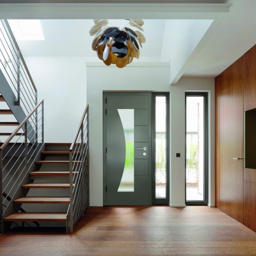 T3TBT0 Plank floor and walnut wall covering in home near staircase