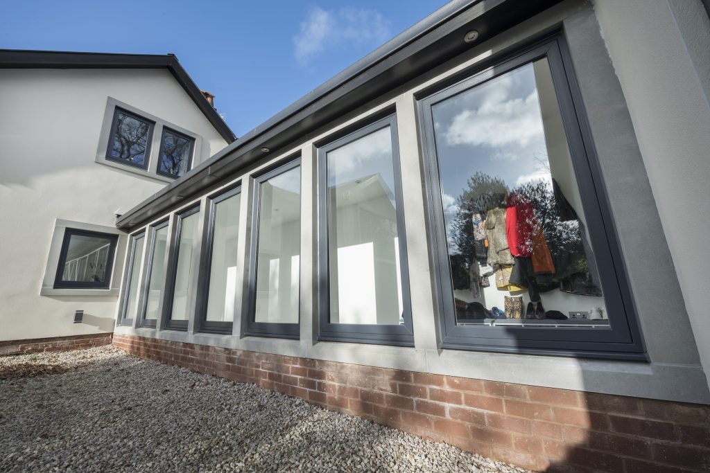 Residence collection R2 wiondow in a side extension with large top hung grey windows